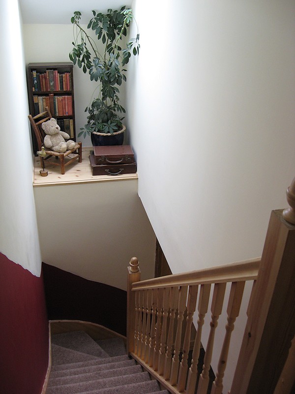 A softwood single turn winder staircase for a loft conversion, all left in natural pine with a clear varnished finish.