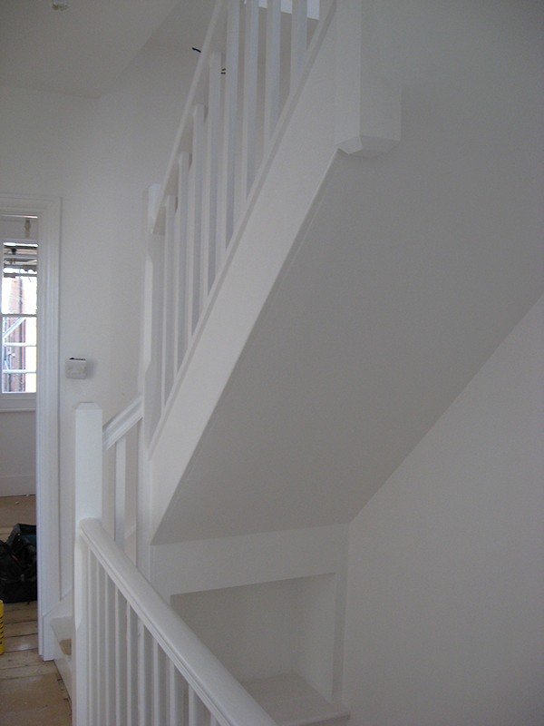 A painted softwood single turn three winder staircase for a loft conversion.