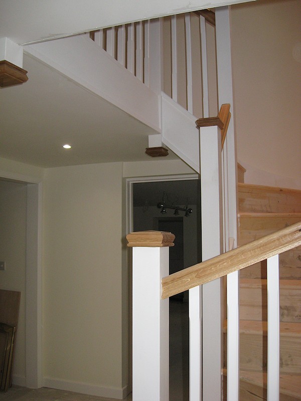 A double turn six winder staircase leading down into a basement.