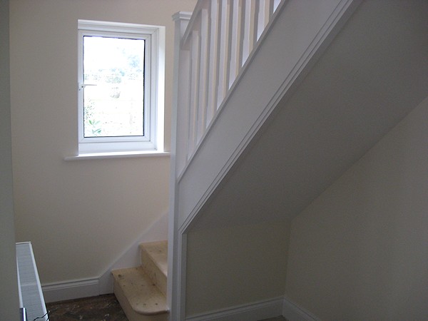 A single turn softwood three winder staircase with a bullnose bottom tread.