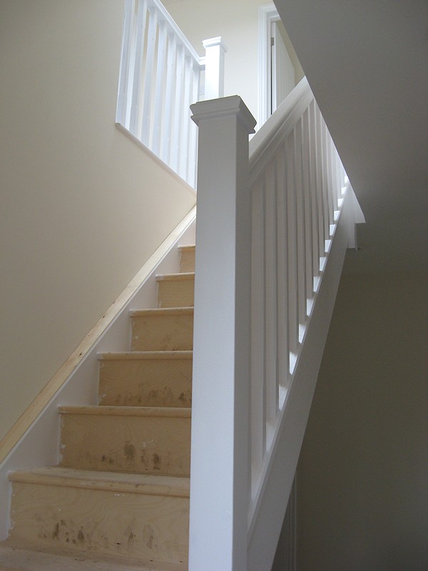 A single turn softwood three winder staircase with a bullnose bottom tread.