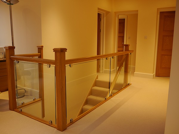 Another oak straight flight starcase with glass balustrade.