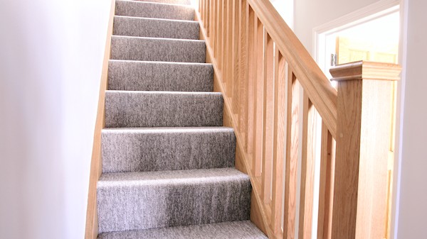 Oak staircase with our std profile handrail, square 32mm spindles and pyramid newel caps.