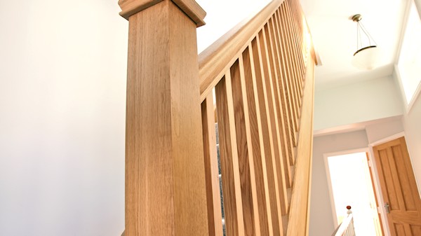 Oak staircase with our std profile handrail, square 32mm spindles and pyramid newel caps.