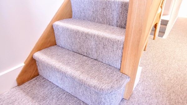 Oak staircase with our std profile handrail, square 32mm spindles and pyramid newel caps.