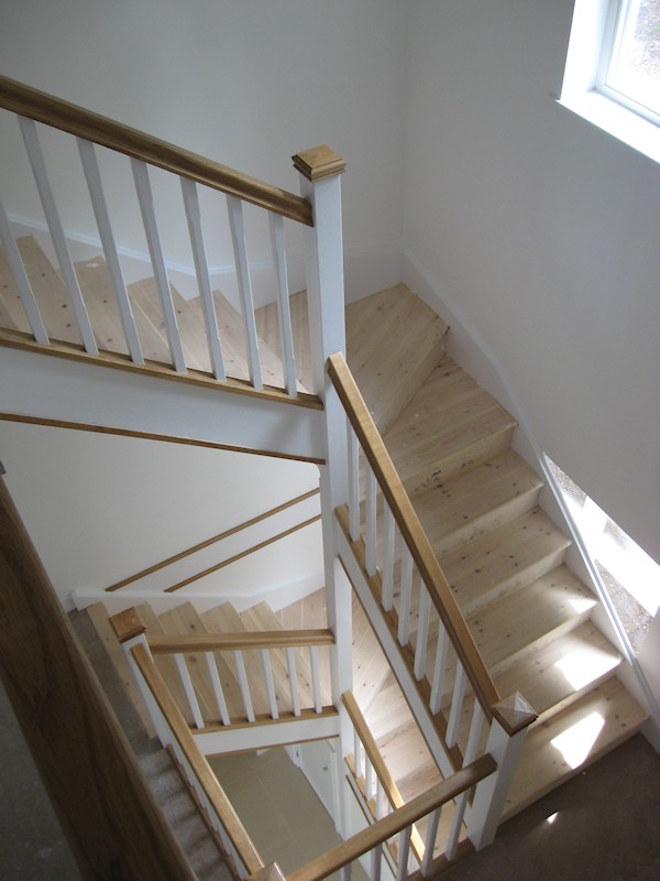 Two winder flights positioned above one another, accessing three floors to this new build large detached family home.