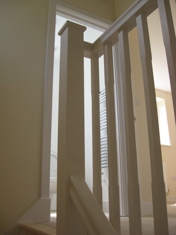 The balustrade comprises of our std handrail, stop chamfer 32mm spindles and flat with rounded edge newel caps.