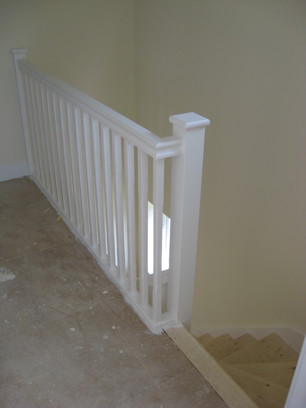 The balustrade comprises of our std handrail, stop chamfer 32mm spindles and flat with rounded edge newel caps.