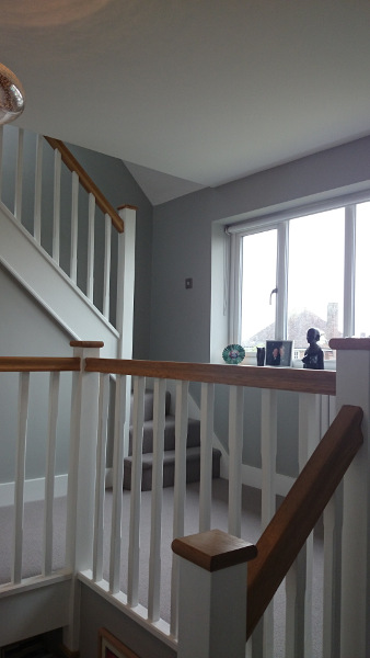 Staircase painted white with our std profile handrail and flat newel caps in oak giving a great contrasting feature.