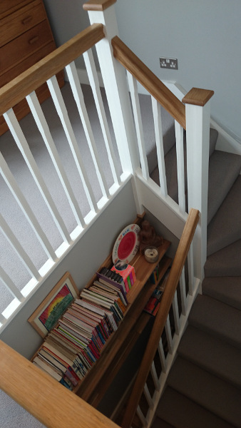 Staircase painted white with our std profile handrail and flat newel caps in oak giving a great contrasting feature.