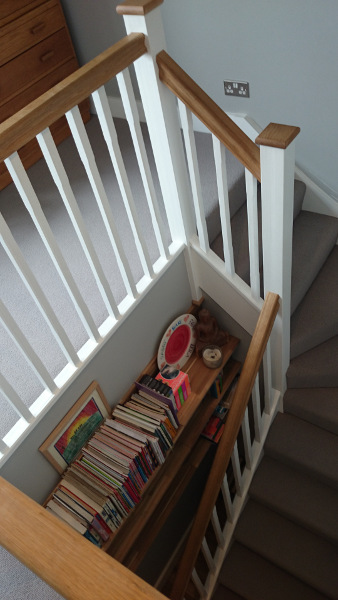 Staircase painted white with our std profile handrail and flat newel caps in oak giving a great contrasting feature.