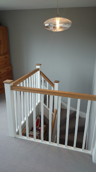 Staircase painted white with our std profile handrail and flat newel caps in oak giving a great contrasting feature.