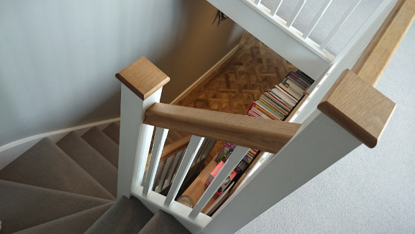 Staircase painted white with our std profile handrail and flat newel caps in oak giving a great contrasting feature.