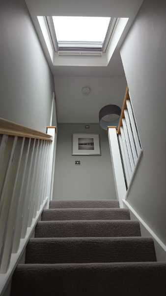 Staircase painted white with our std profile handrail and flat newel caps in oak giving a great contrasting feature.