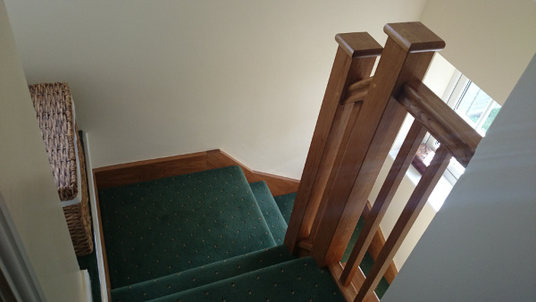 Oak construction staircase including our std handrail, square spindles and flat newel caps.