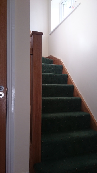 Oak construction staircase including our std handrail, square spindles and flat newel caps.