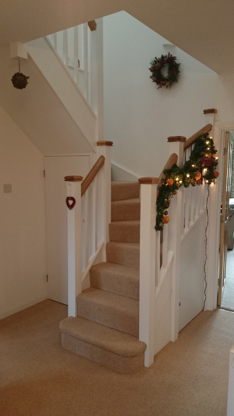 Staircase for loft onversion in bungalow incorporating six winders, along with oak ornate handrail and pyramid caps.