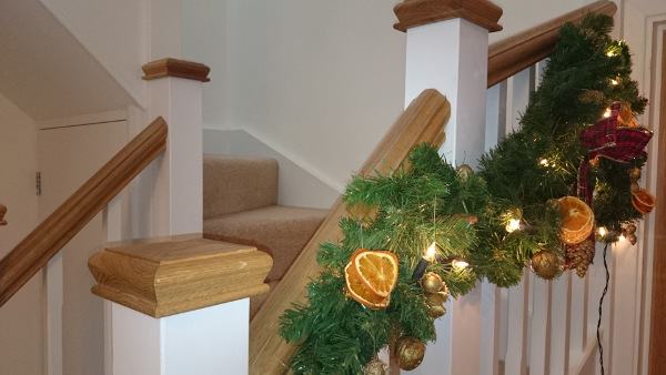 Staircase for loft onversion in bungalow incorporating six winders, along with oak ornate handrail and pyramid caps.