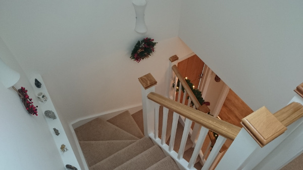 Staircase for loft onversion in bungalow incorporating six winders, along with oak ornate handrail and pyramid caps.