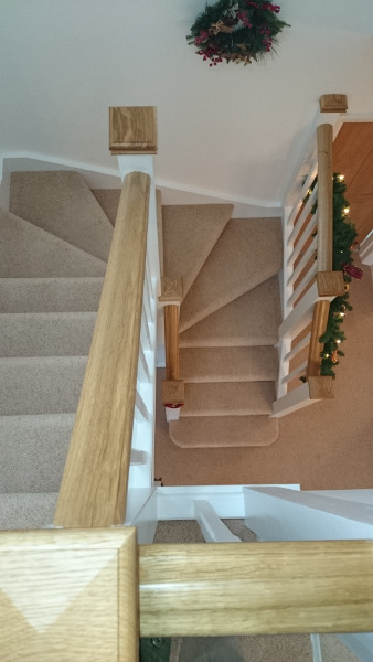 Staircase for loft onversion in bungalow incorporating six winders, along with oak ornate handrail and pyramid caps.