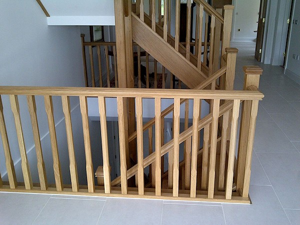 All european oak construction staircase comprising of stop chamfer newels/spindles and ornate handrail