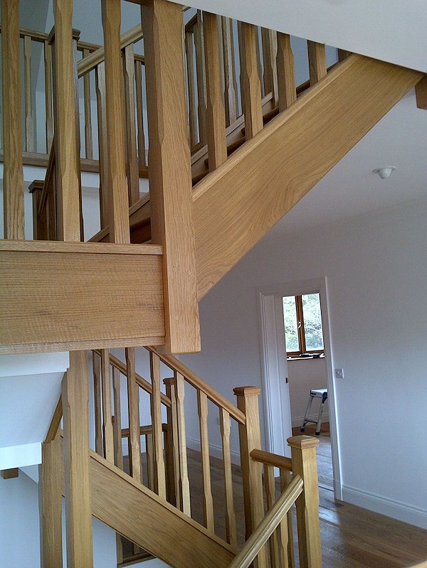 All european oak construction staircase comprising of stop chamfer newels/spindles and ornate handrail