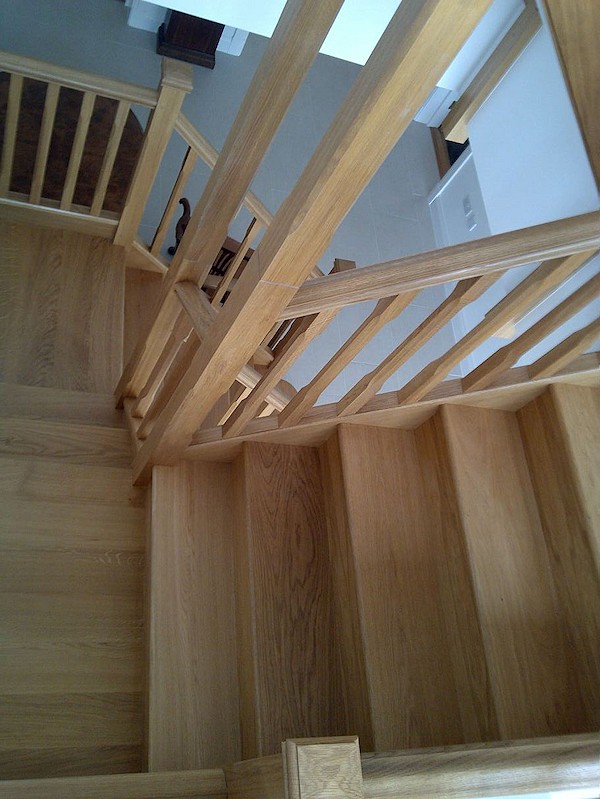 All european oak construction staircase comprising of stop chamfer newels/spindles and ornate handrail