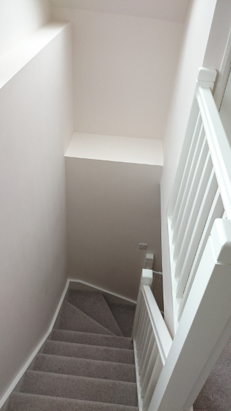 Room in the roof double winder staircase, all redwood painted.