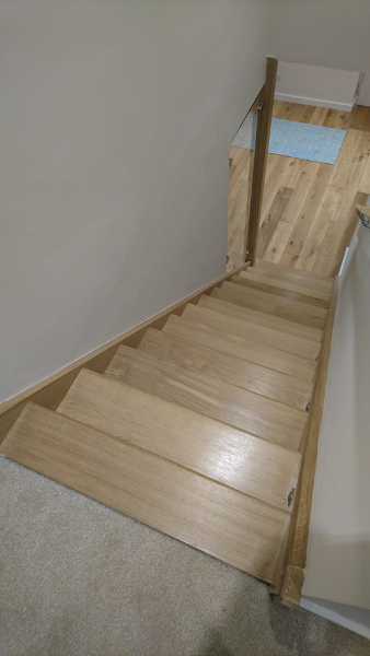 A straight flight staircase in oak.