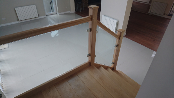 Small oak construction staircase with glass infill panels.
