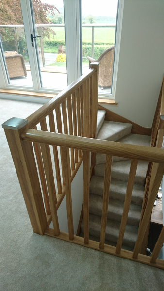 Oak winder staircase using our crown profile handrail.