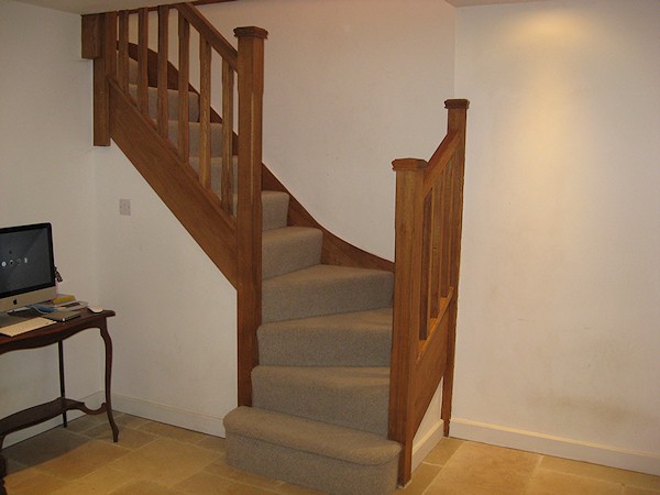 An oak double winder staircase for a farmhouse refurbishment.